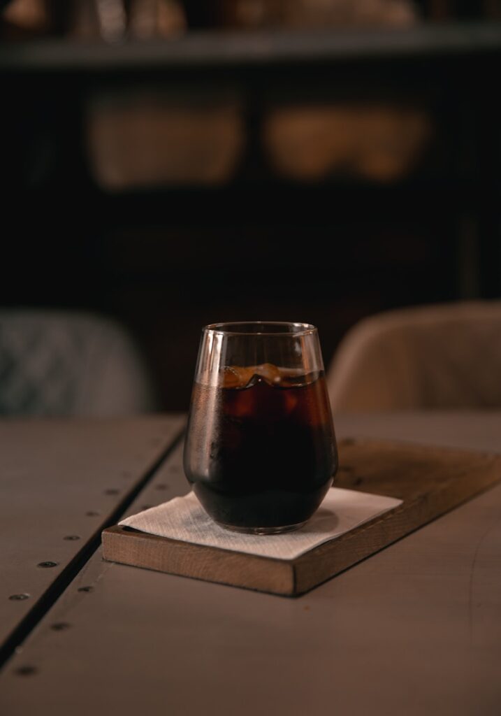 clear drinking glass on brown wooden table